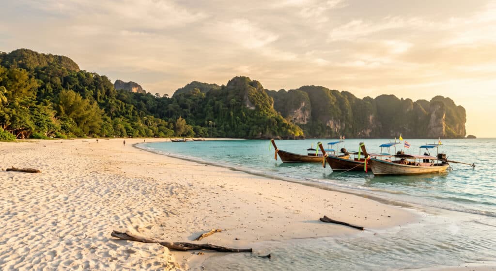 Longtail boats on a Koh Phangan beach at sunset